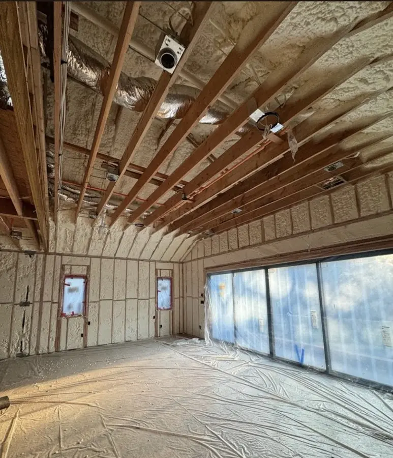 Interior walls and ceiling insulated with spray foam during new construction in Hampstead